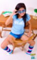 Boon seated lowering sunglasses wearing shorts legs spread
