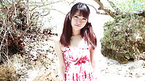 Standing at beach dunes long hair in pigtails wearing summer dress