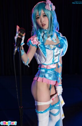 Ria Kurumi standing at microphone lowering her panties