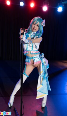 Ria Kurumi standing at microphone lowering her panties