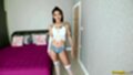 Standing beside bed wearing underwear in stockings