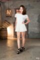 Standing with hand on hip wearing white dress high heels