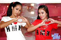 Amanda and Sarah wearing tshirts making hearts long hair in ponytail