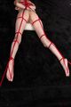 On her front naked bound with red shibari rope bare feet
