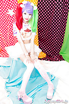 Knees pressed together hair in pigtails wearing stockings high heels