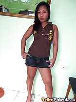 Wearing brown top and denim shorts long hair hands on hips