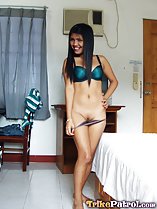 Pushing panties down over her shaved pussy hand on hip long hair over her blue bra